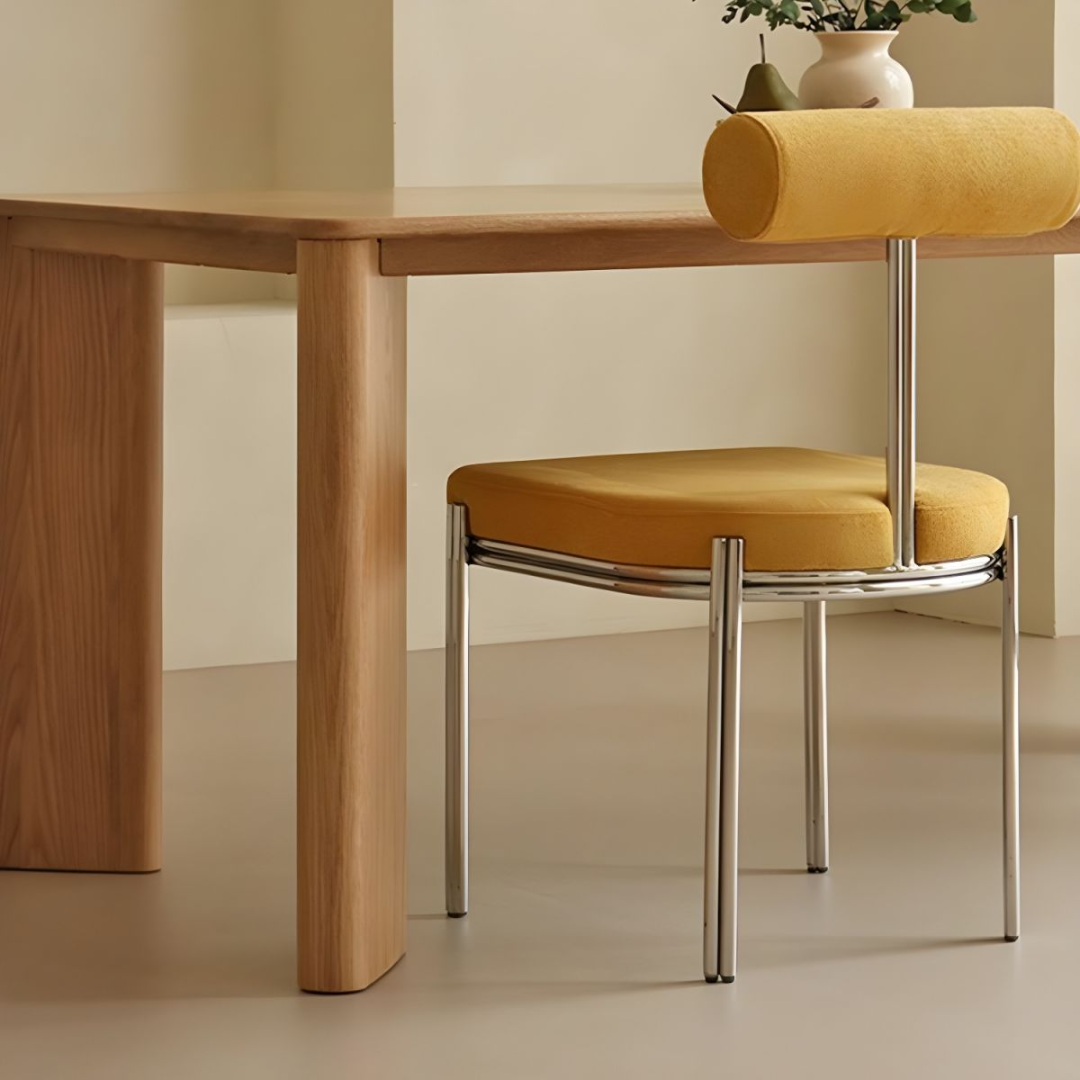Rectangular Wooden Dining Table with a yellow cushioned chair in a minimalistic setting.